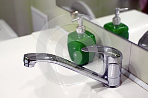 Metal tap and green tankÂ  for soap